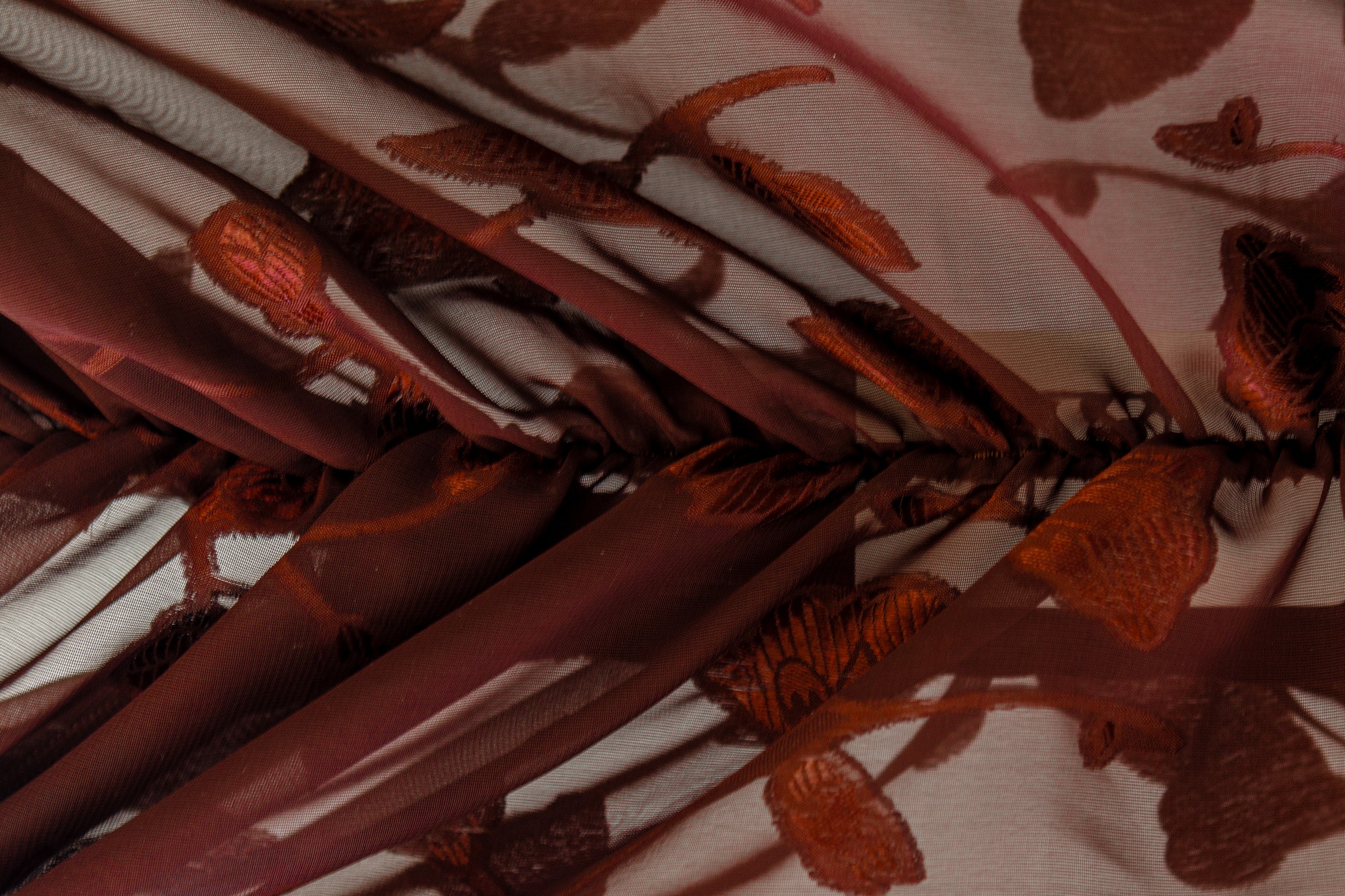 Burgundy floral fabric, macro